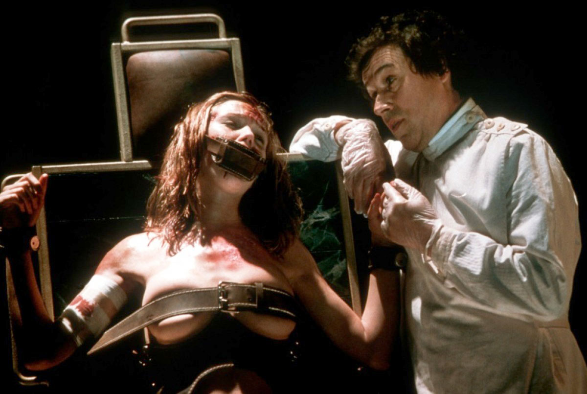 Anonymous victim (left) and Stephen Rea in <em>FEARDOTCOM</em>.